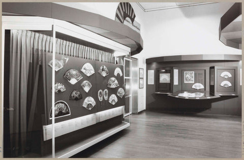 Room with a display case with various fans, to the right of them framed fan sheets and a book with drawings, c. 1992 - c. 1993 Canvas Print