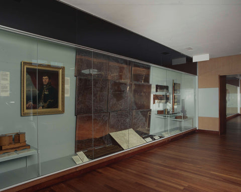 Corner of a room with a portrait and a display case containing, among other things, a map of the Netherlands, 1999 Canvas Print