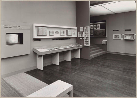 Room with various objects including books in display cases, a television screen and a staircase, c. 1975 Canvas Print