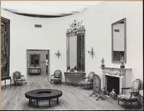 Room with chairs, mirrors, a fireplace with fireplace screen, a tapestry and in the middle a round sofa for visitors, 1962 Canvas Print