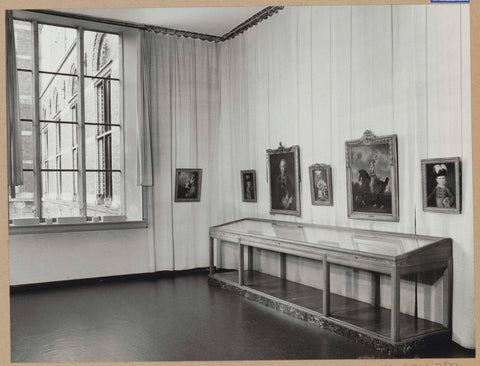 Room 115 seen to the northwest with paintings above a leg display case and a window on the left, 1963 Canvas Print