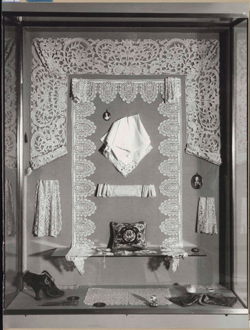 Display case with various objects of lace, a shoe and miniatures, c. 1958 Canvas Print