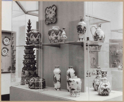 Display case with ceramic objects, including vases and a flower pyramid, c. 1959 Canvas Print