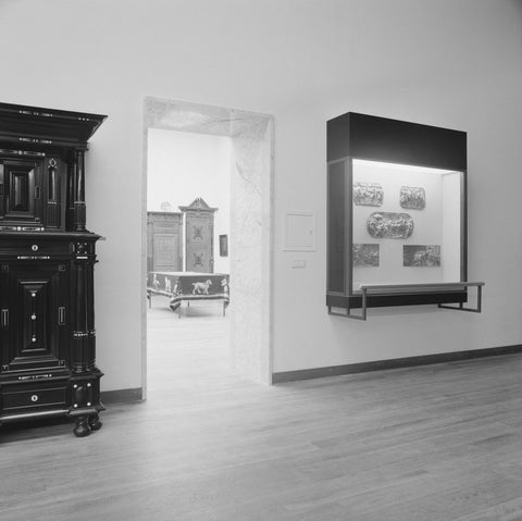 Room with cupboard and display case with reliefs and passage with a view of a table with upholstery, 1962 Canvas Print