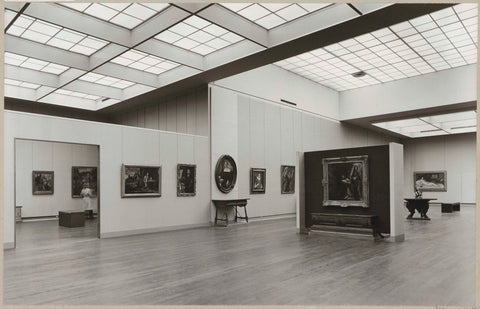 Room 212A with paintings including portraits and a retent lying nude, a table with statue, benches for visitors and a built-in wall with passage, c. 1973 - c. 1974 Canvas Print