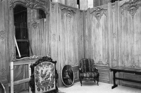 Paneling with fireplace screen, oval painting, table and armchair, 1957 Canvas Print