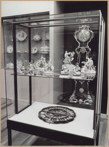 Display case with ceramic objects, in the background a timepiece, 1962 Canvas Print