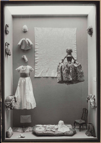 Display case with miniature-sized clothing and a doll with a robe à la française, 1962 Canvas Print