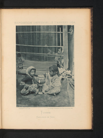 Two children play for a woman behind a loom in the Tunisian part of the Antwerp World's Fair in 1894, Charles Bernhoeft, 1894 Canvas Print