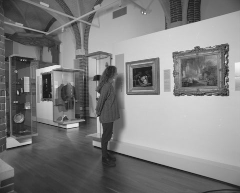 Woman looks at two paintings on a panel, 1996 Canvas Print