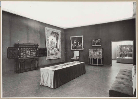 Room with tapestries, paintings, a table with books, furniture, sofas and a passageway, c. 1957 Canvas Print