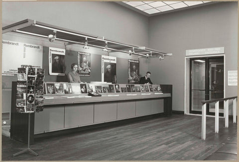 Counter with reproductions and two employees, right the entrance to the exhibition, c. 1969 Canvas Print