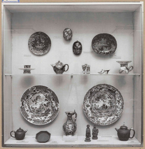 Display case with ceramic objects, including dishes, a jug, a muzzle, teapots and figurines, c. 1959 Canvas Print