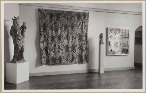 Two statues next to a rug and a display case with various objects, 1946 - 1951 Canvas Print