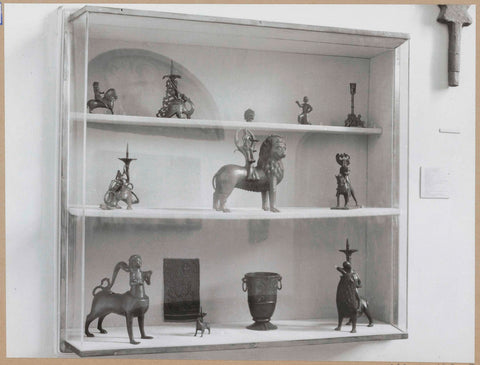 Display case with various metal objects including animal figures, c. 1959 Canvas Print