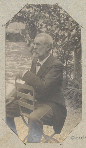 Portrait of a man with a beard, sitting backwards on an open-air chair, presumably in France, anonymous, c. 1890 - c. 1900 Canvas Print