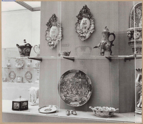 Display case with ceramic objects, including a bowl, candlesticks, boxes, a jug and slippers, c. 1959 Canvas Print