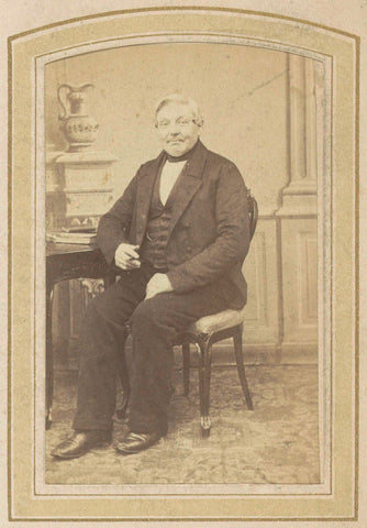 Portrait of a sitting man at a table, anonymous, c. 1860 - c. 1900 Canvas Print