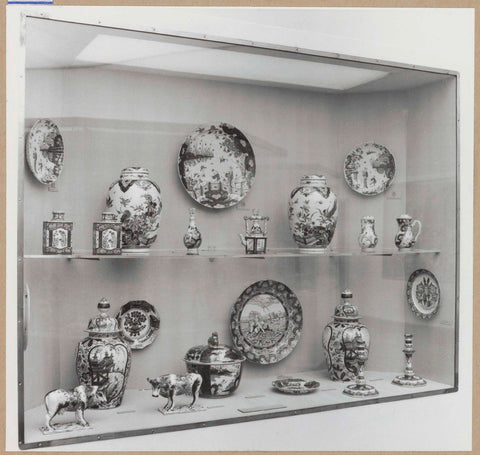 Display case with ceramic objects, including bowls, vases, candlesticks and two animal figures, c. 1959 Canvas Print