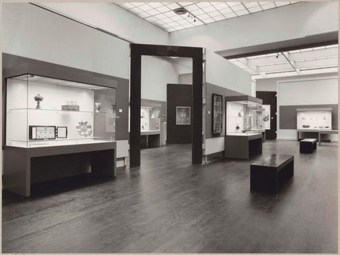 Room with various objects in display cases and a partition with a passage in the middle, c. 1978 - c. 1979 Canvas Print