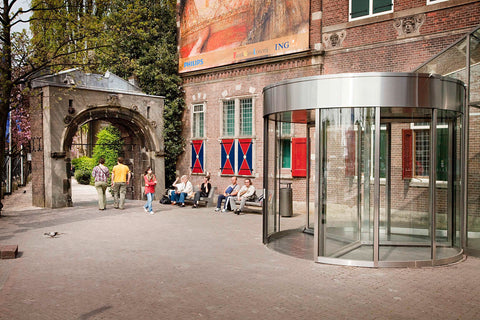 Visitors sitting on benches next to the revolving door of the exit, 2010 Canvas Print