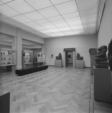 Room with two statues on pedestals next to a passage and small objects in display cases, 1983 Canvas Print