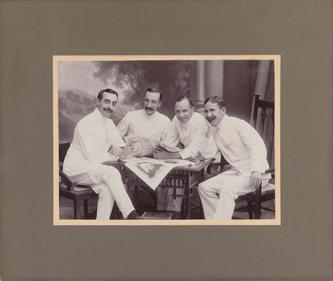 Group portrait of four Europeans posing with a newspaper, Surabaya, anonymous, 1910 Canvas Print