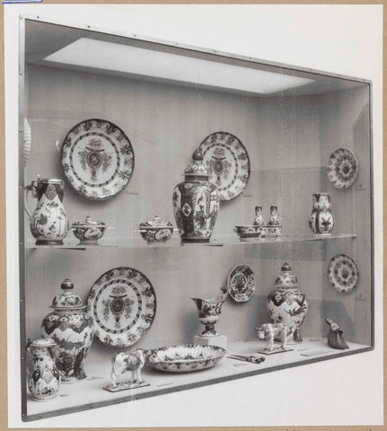 Display case with ceramic objects, including bowls, candlesticks and two animal figures, c. 1959 Canvas Print