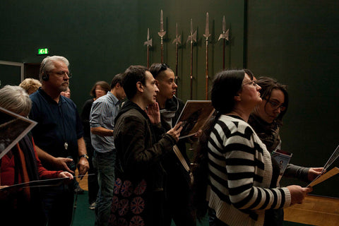 Visitors standing in front of a wall with four hellbezas and two partisans, 2009 Canvas Print