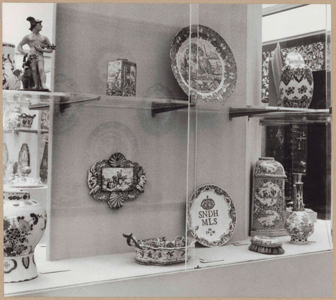 Display case with ceramic objects, including a plate, a pot and a brush, c. 1959 Canvas Print