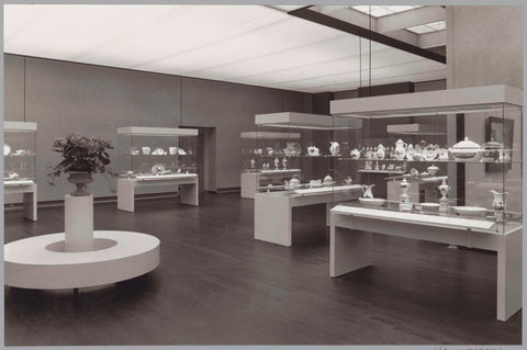 Room with various objects in display cases and a round bench for visitors with a flower arrangement, c. 1988 Canvas Print