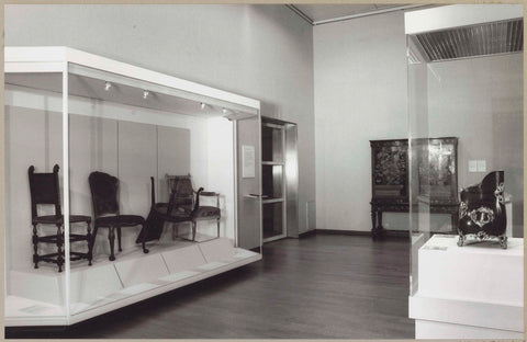 Room with various objects including a cupboard and chairs in a display case, c. 1993 Canvas Print