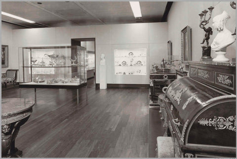 Room with furniture including chairs, tables, cupboards and display cases with (presumably) silverware and busts, 1983 Canvas Print