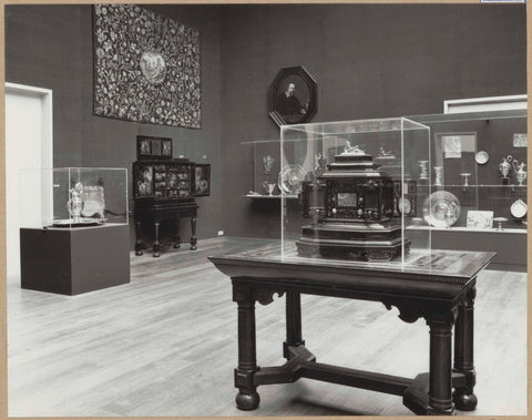 Room with furniture including art cabinets, a table, a tapestry and a display cases with precious metal objects, 1962 Canvas Print