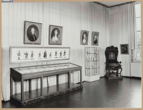 Room 115 seen to the southwest with portraits, display cases and a chair, 1963 Canvas Print