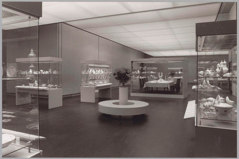 Room with various objects in display cases including a set table, in the foreground a round sofa for visitors with a flower arrangement, c. 1988 Canvas Print