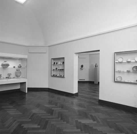 Room with two wall display cases with bowls next to a passage on the right, 1983 Canvas Print