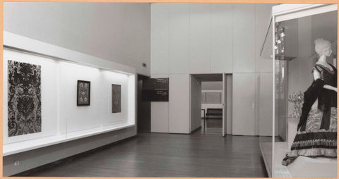 Room with on the right a display case with a robe and two candelabra, on the left frames with interior fabric and embroidery, c. 1994 Canvas Print