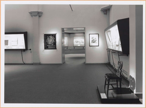 Room of the Rijksprentenkabinet with various objects in display cases and a chair with carved backrest, c. 1998 Canvas Print